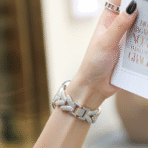 Close-up of V-shape diamond metal strap on woman's wrist