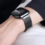 Detailed view of a black Magnetic Milanese Loop Apple Watch band on a wrist